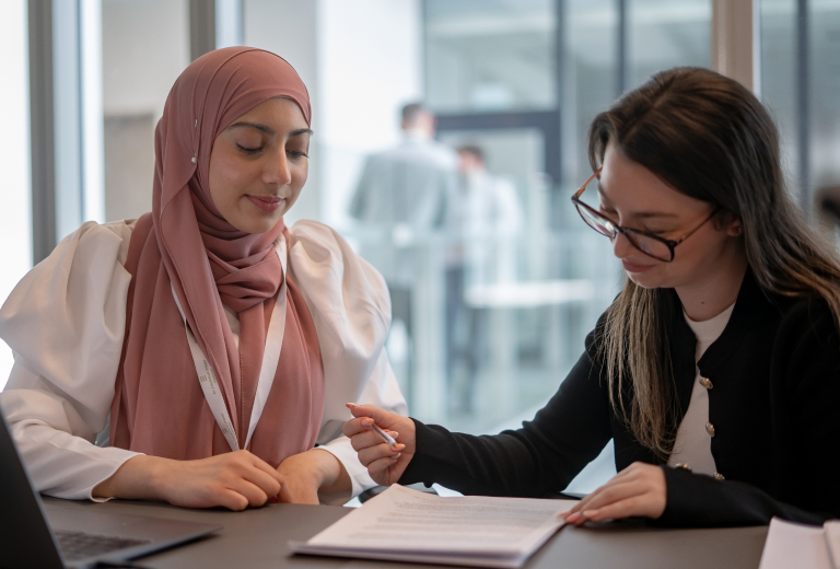 Two female MRS solicitors working together on document